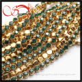 long decorative brass chain with emerald crystal